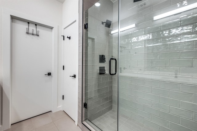 bathroom featuring a shower stall and tile patterned flooring