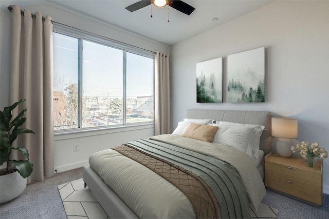 carpeted bedroom with baseboards and a ceiling fan