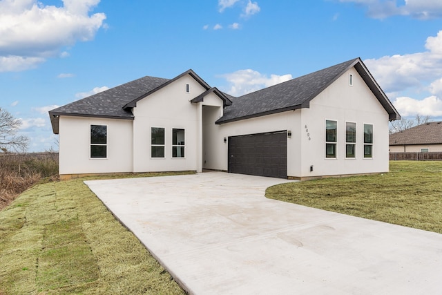 view of front of property featuring a garage and a front yard