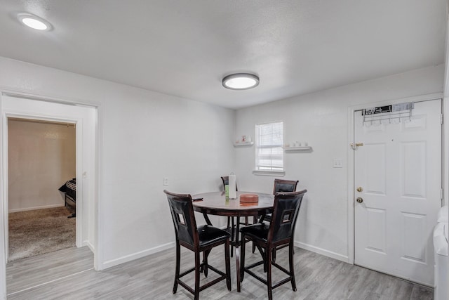 dining area with light hardwood / wood-style floors