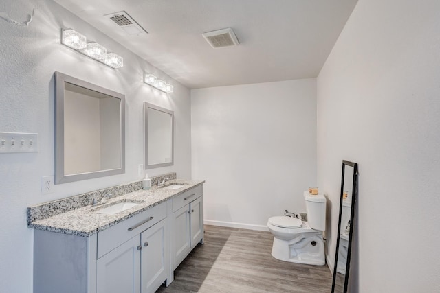 bathroom featuring hardwood / wood-style flooring, vanity, and toilet