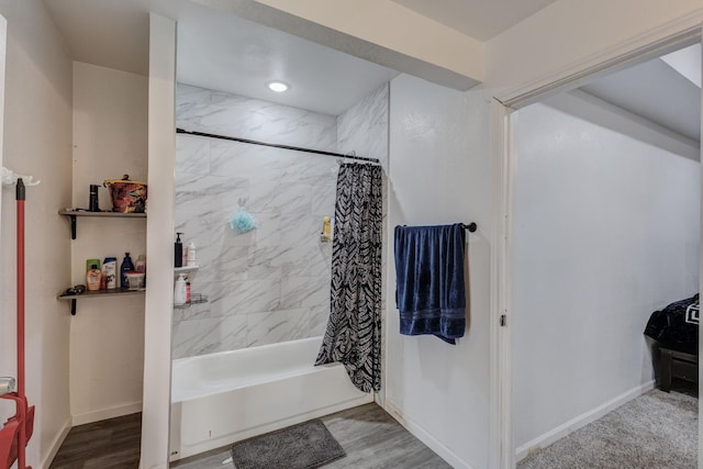 bathroom featuring shower / tub combo with curtain and wood-type flooring