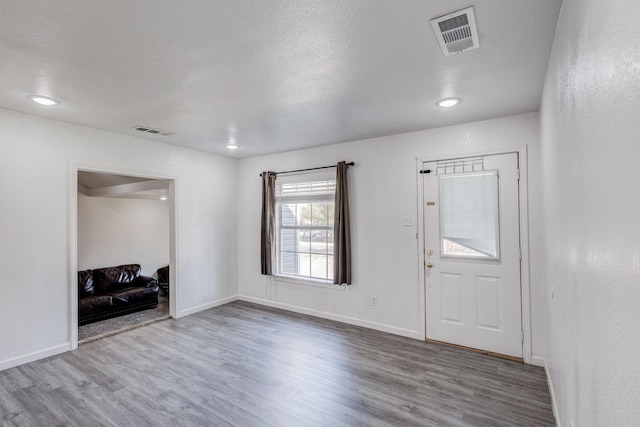 entrance foyer featuring wood-type flooring and a textured ceiling