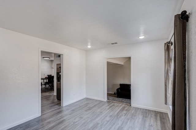 unfurnished room with light hardwood / wood-style floors