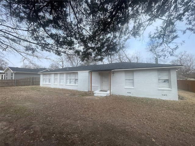 rear view of property featuring a lawn