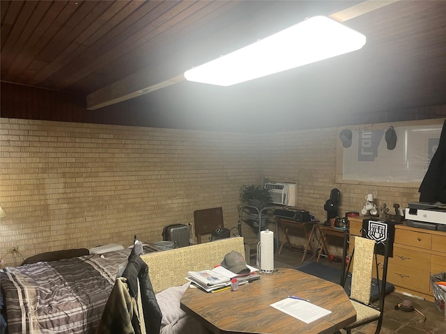 dining room featuring brick wall