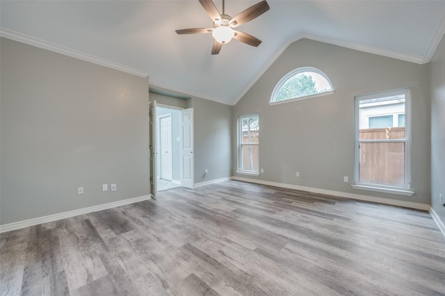 unfurnished room with ornamental molding, vaulted ceiling, light hardwood / wood-style floors, and ceiling fan