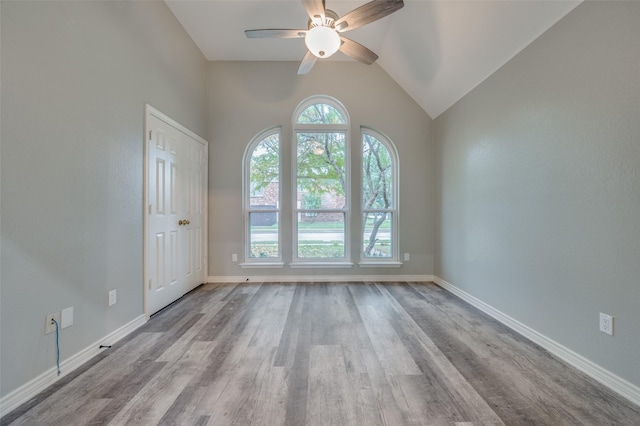 unfurnished room with vaulted ceiling, ceiling fan, a healthy amount of sunlight, and light hardwood / wood-style floors