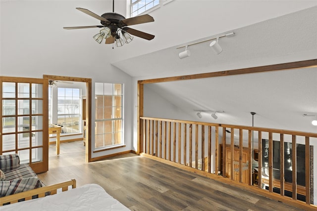 interior space featuring ceiling fan, lofted ceiling, a healthy amount of sunlight, and light hardwood / wood-style flooring