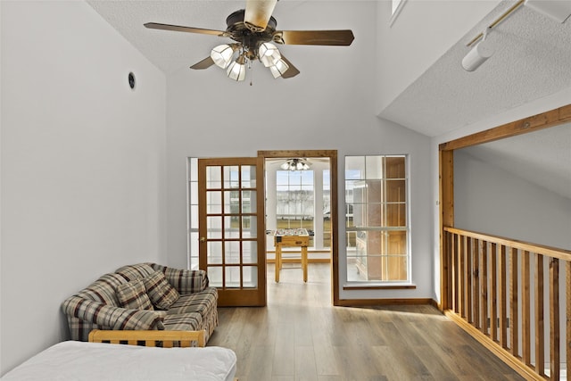 sitting room featuring ceiling fan, hardwood / wood-style floors, and a textured ceiling