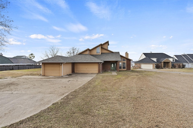 view of front of house with a garage and a front yard