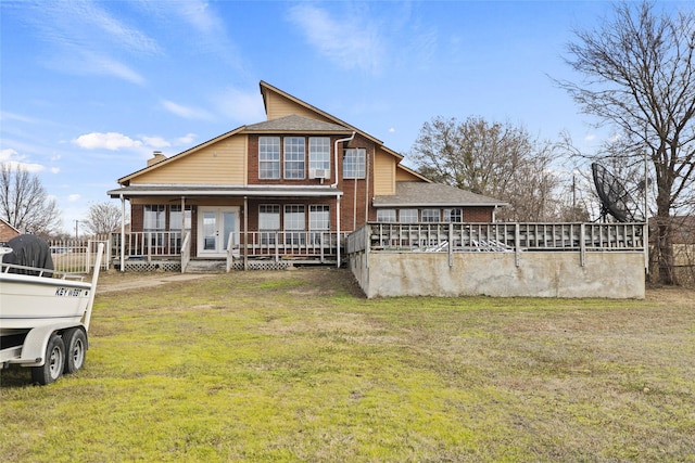 back of property with a porch and a yard