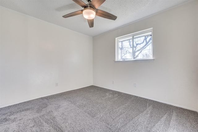 carpeted empty room featuring ceiling fan and a textured ceiling