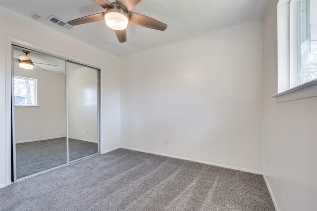 unfurnished bedroom featuring a closet, ceiling fan, and carpet flooring