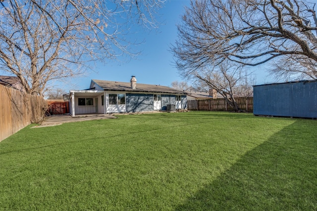 back of property with a yard and a patio area