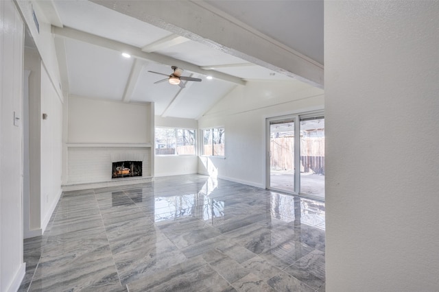 unfurnished living room with lofted ceiling with beams, ceiling fan, and a fireplace