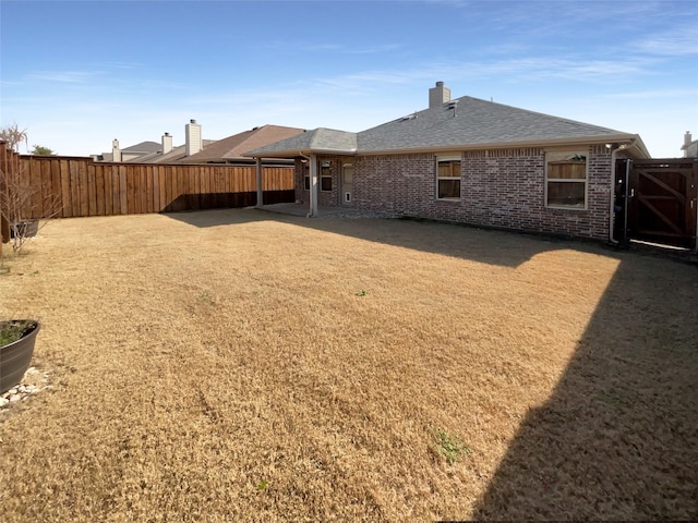 rear view of house with a yard