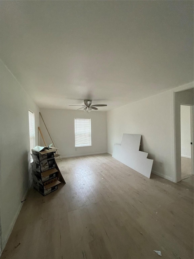 interior space with ceiling fan and light wood-type flooring