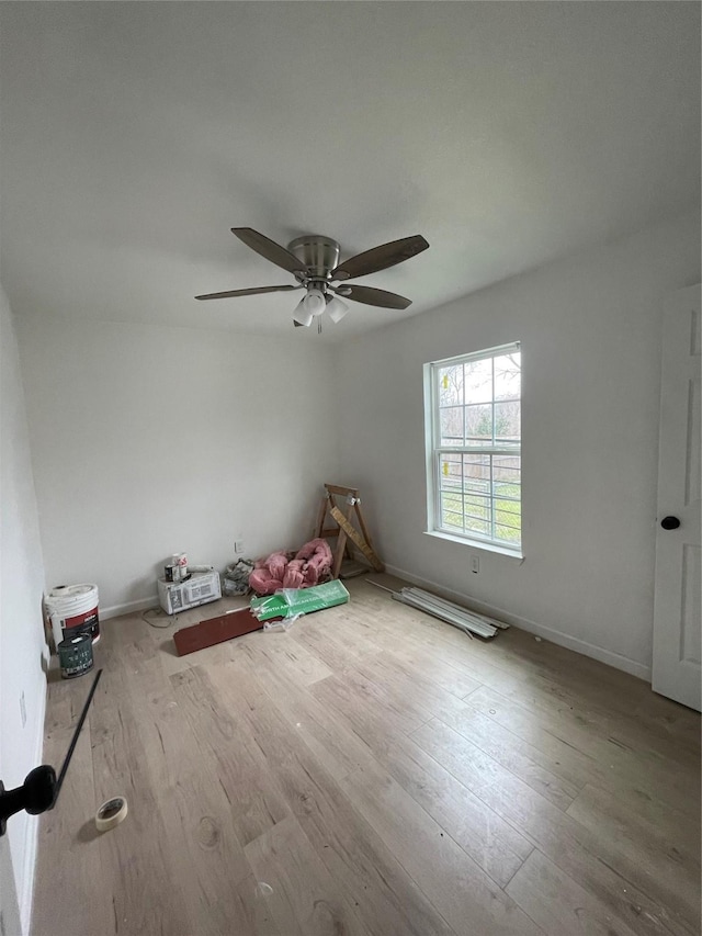 spare room featuring light hardwood / wood-style flooring and ceiling fan