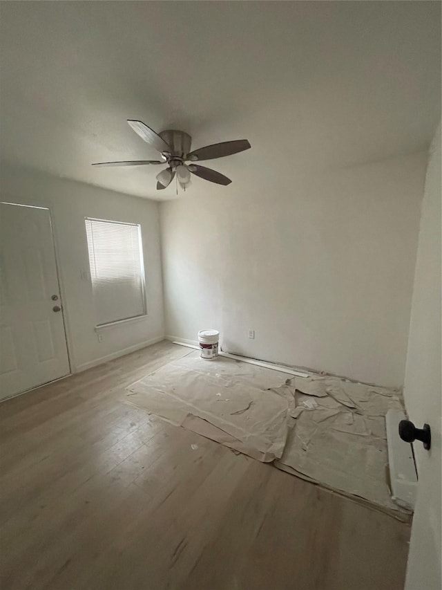 spare room with ceiling fan and light hardwood / wood-style floors