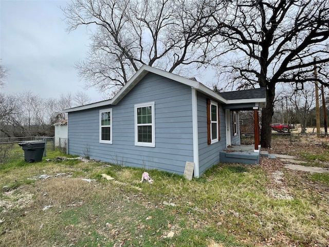 view of side of property with a yard