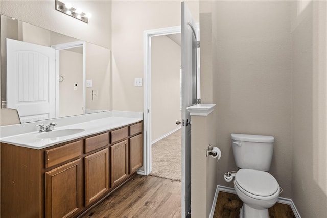 bathroom featuring hardwood / wood-style flooring, vanity, and toilet