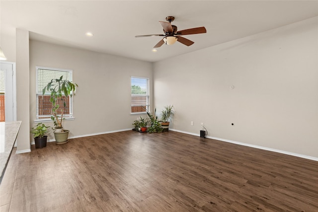 spare room with dark hardwood / wood-style floors and ceiling fan