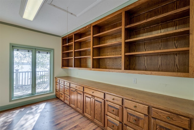 unfurnished office with crown molding and light hardwood / wood-style floors