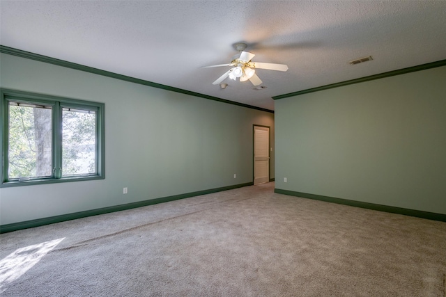 carpeted empty room with crown molding, ceiling fan, and a textured ceiling