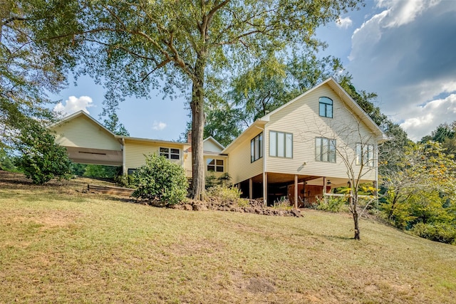 rear view of property with a lawn