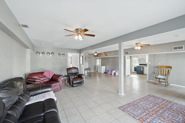 living area with a ceiling fan, visible vents, baseboards, and light tile patterned flooring