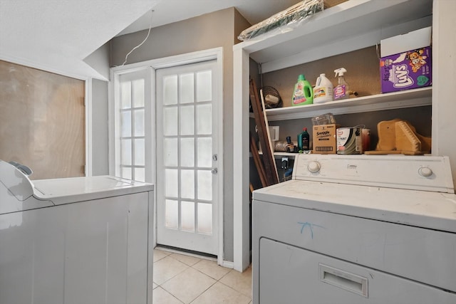 laundry room with light tile patterned floors, laundry area, and independent washer and dryer