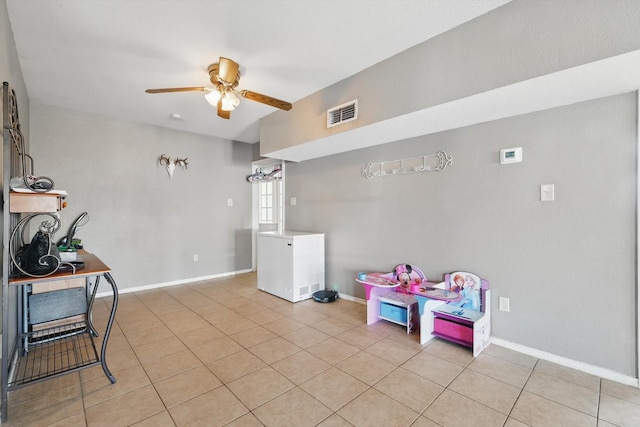 playroom with ceiling fan, visible vents, baseboards, and light tile patterned flooring