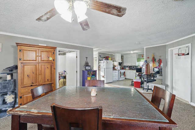 dining room with light carpet, a ceiling fan, ornamental molding, and a textured ceiling