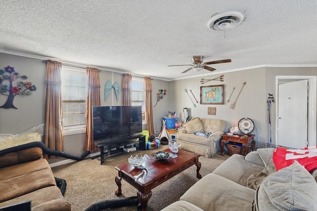 living room with a textured ceiling, carpet floors, visible vents, a ceiling fan, and ornamental molding