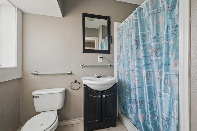 full bath with a stall shower, baseboards, toilet, tile patterned floors, and vanity