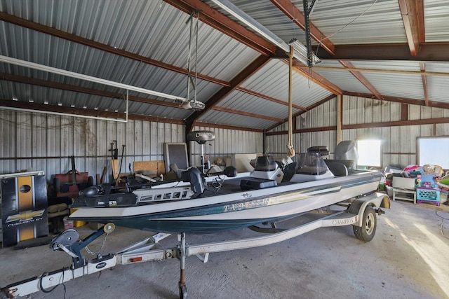 garage with metal wall and a garage door opener