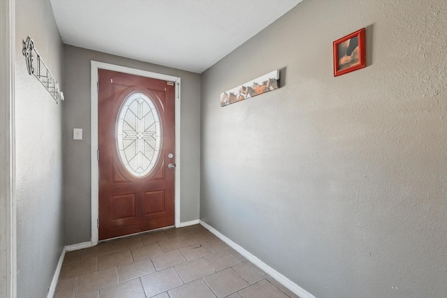 doorway to outside featuring baseboards