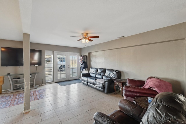 living room featuring light tile patterned floors, ceiling fan, french doors, and visible vents