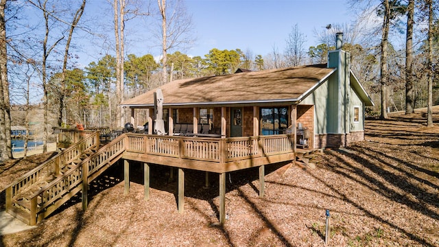 back of house featuring a deck