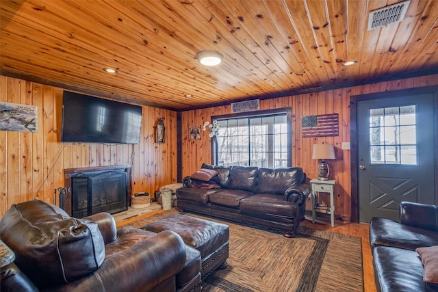 living room featuring wood ceiling, wood walls, plenty of natural light, and hardwood / wood-style flooring