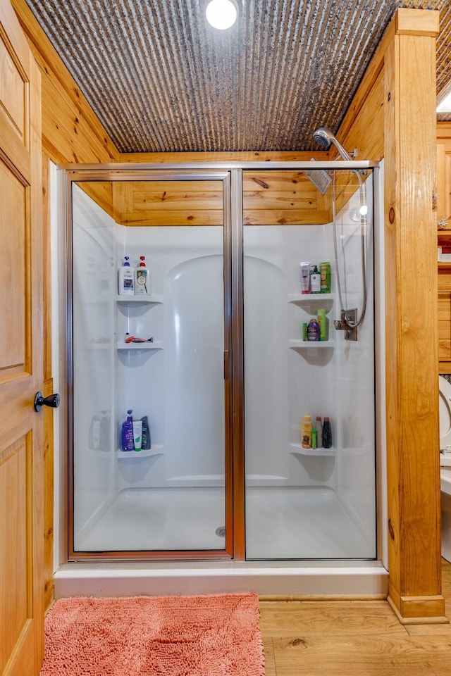 bathroom featuring hardwood / wood-style floors and walk in shower