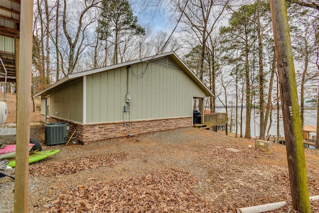 view of property exterior with central AC unit and a wooden deck