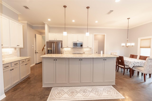 kitchen featuring white cabinetry, appliances with stainless steel finishes, a kitchen island with sink, and hanging light fixtures