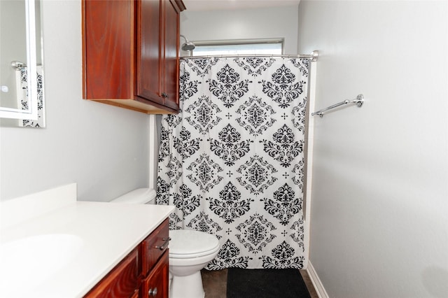 bathroom with vanity, toilet, and curtained shower