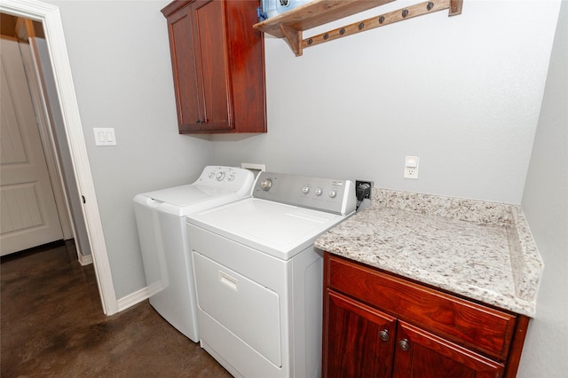 laundry room featuring cabinets and washer and dryer