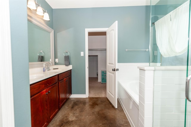 bathroom featuring vanity, concrete flooring, and a tub