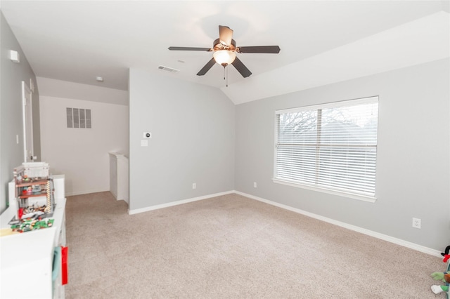 interior space featuring lofted ceiling, light carpet, and ceiling fan