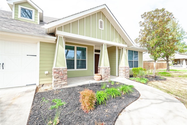 view of front of property with a porch and a garage