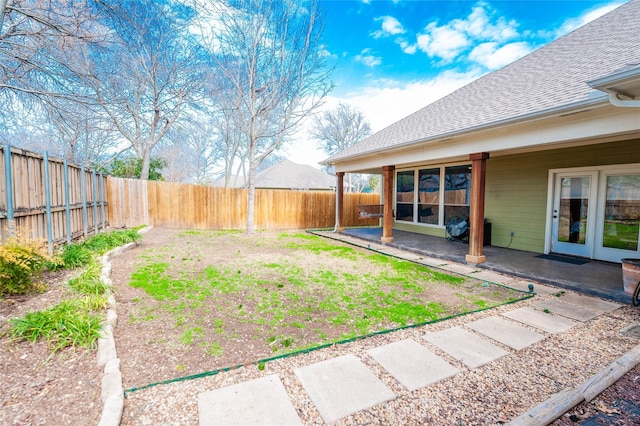 view of yard with a patio and french doors